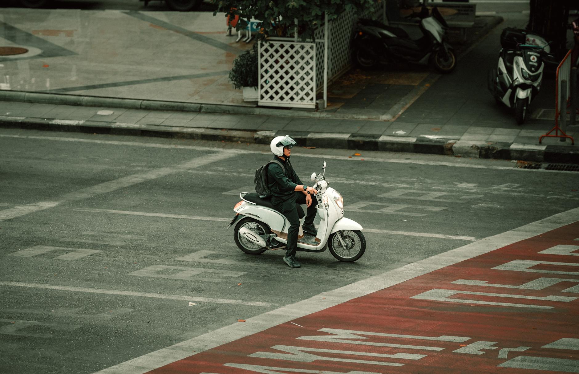Skuterzysta czekający na skrzyżowaniu w zatłoczonym mieście Bangkok